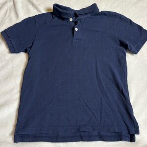 Two Navy children place polo tops